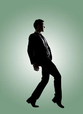 Silhouette of Asian businessman dancing or posing, isolatedの写真素材