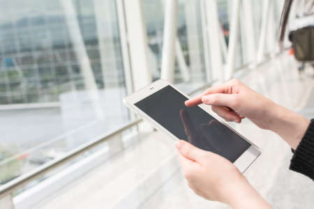 woman using pad in the airportの写真素材