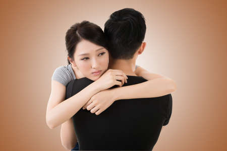 Asian young couple hug and comfort, closeup portraitの写真素材