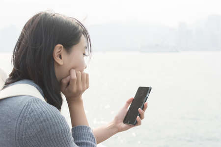 Woman use of mobile phone at outdoorの写真素材