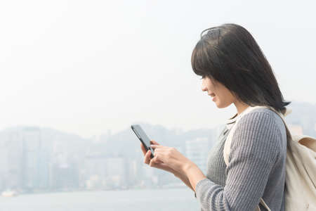 Woman use of mobile phone at outdoorの写真素材