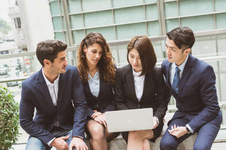 Business people working on laptop computer at outdoor