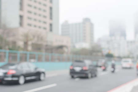 Abstract urban background with blurred buildings and street, shallow depth of focus.の写真素材