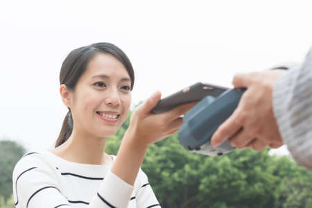 Woman pay on pos machineの写真素材