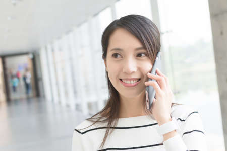 Asian young woman use cellphoneの写真素材
