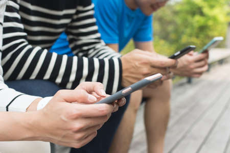 Group of people using smartphone togetherの写真素材