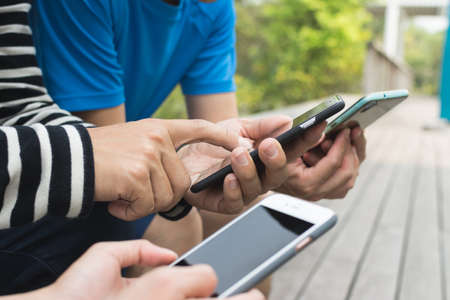Group of people using smartphone togetherの写真素材