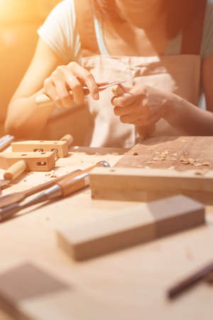 woman carpentry at home, wooden work conceptの写真素材