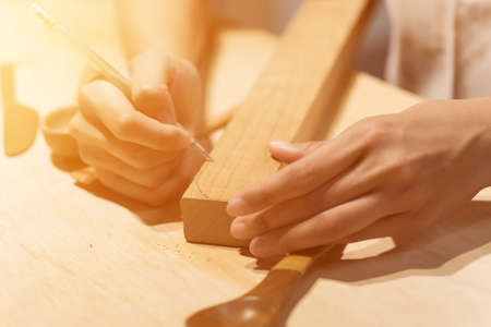 woman carpentry at home, wooden work conceptの写真素材