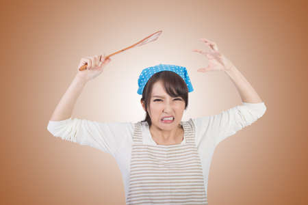 Mad Asian housewife, closeup portrait.