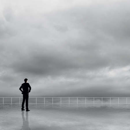 Man look and discover against the cloudy sky with copyspace.の写真素材