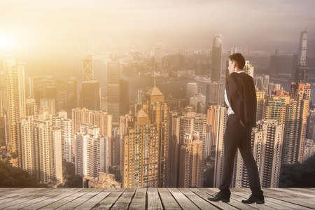 Businessman hold his coat after work and walk to somewhere.の写真素材