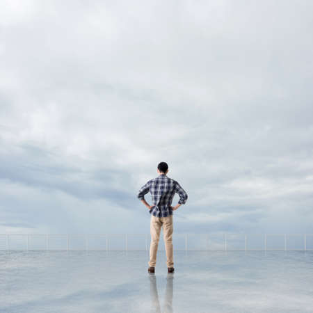 Man look and discover against the cloudy sky with copyspace.の写真素材