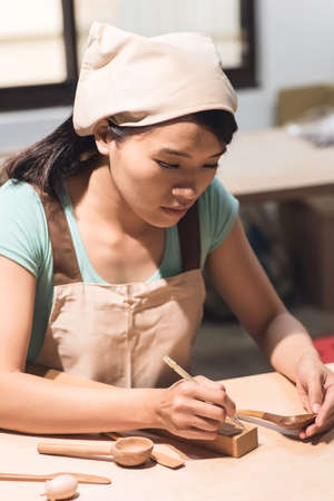 woman carpentry at home, wooden work conceptの写真素材