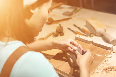 woman carpentry at home, wooden work conceptの写真素材