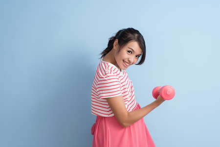 asian young pregnant sport by using dumbbellの写真素材