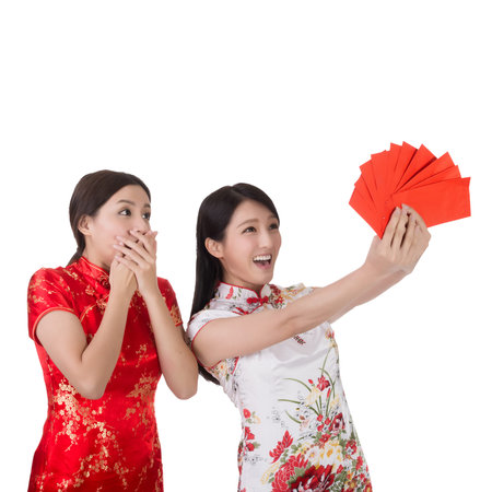 Attractive Chinese woman dress traditional cheongsam and hold red envelopeの写真素材