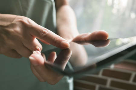 Closeup portrait of Asian woman using smartphone, concept of technology or communication.の写真素材