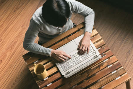 concept of woman work at home, Asian woman using laptop in a roomの写真素材