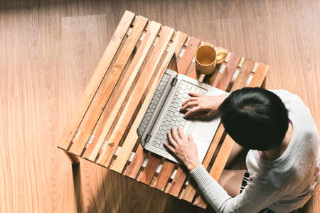 concept of woman work at home, Asian woman using laptop in a roomの写真素材