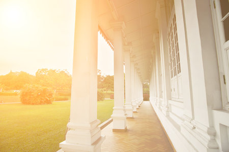 Architecture of corridor in white house near green grassland.の写真素材