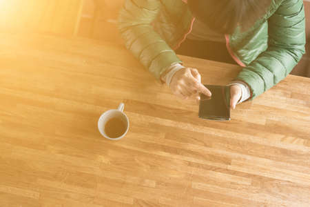 using cellphone with copyspace at homeの写真素材