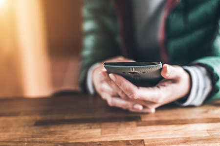 using cellphone with copyspace at homeの写真素材