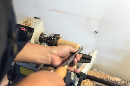 worker turning wood on a lathe