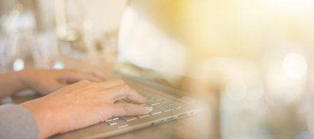 concept of working at home by woman using laptop on table with copyspace
