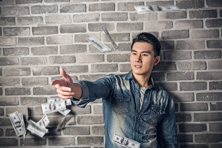 Asian young man throw the cashの写真素材