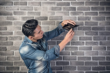 poor Asian young man hold the empty wallet