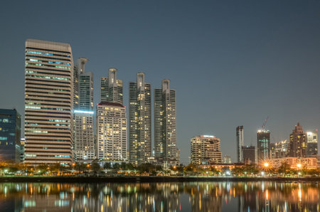 cityscape of night with skyscrapers and lake at bangkok, asia
