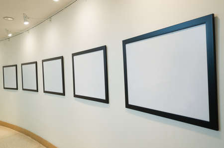 blank white picture frame on wall with nobodyの写真素材