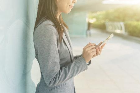 business woman using smartphone at city, bangkok, asia
