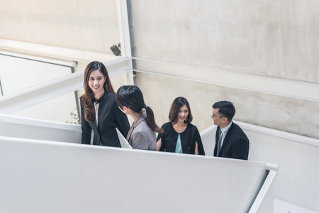 asian business group talk at the stairsの写真素材