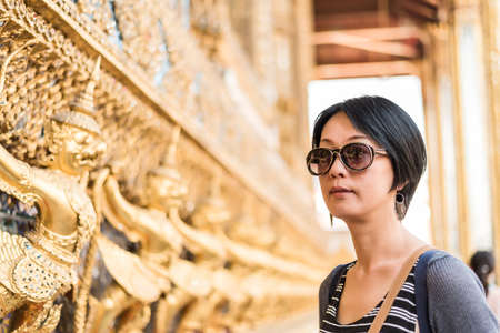 asian woman travel at the famous temple of Grand Palace, Bangkok, Asiaの写真素材
