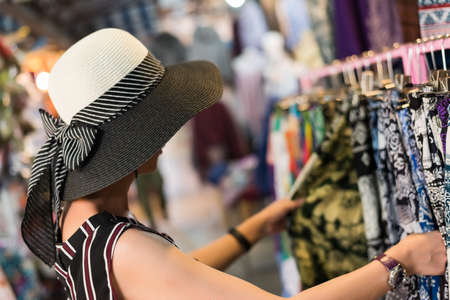 asian young woman traveling and shopping at Chatuchak weekend market, Bangkok, Thailandの写真素材