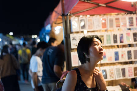 asian woman shopping at the night market in bangkokの写真素材