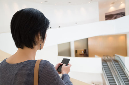 asian woman using cellphone with copyspace