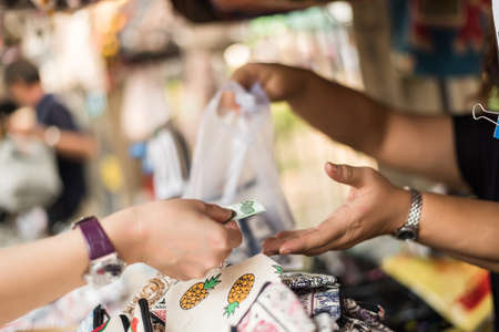 asian young woman traveling and shopping at Chatuchak weekend market, Bangkok, Thailandの写真素材