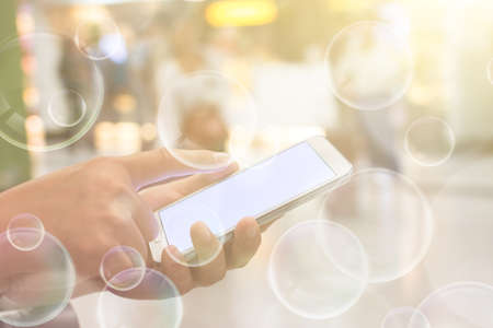 Using smartphone in a market or department store, closeup image.の写真素材