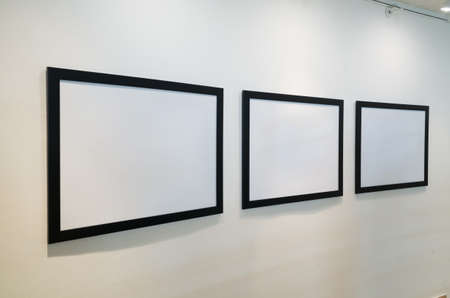 blank white picture frame on wall with nobodyの写真素材