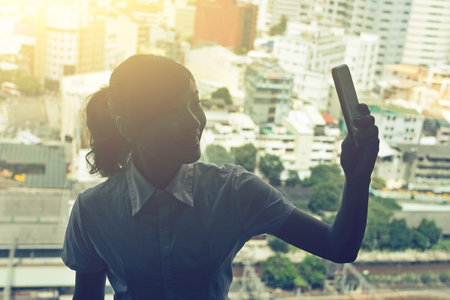 Business woman selfie near the window in hotel room.