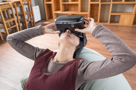 mature woman using vr headset in the house