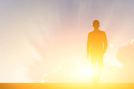 silhouette of business man walk on sunsetの写真素材