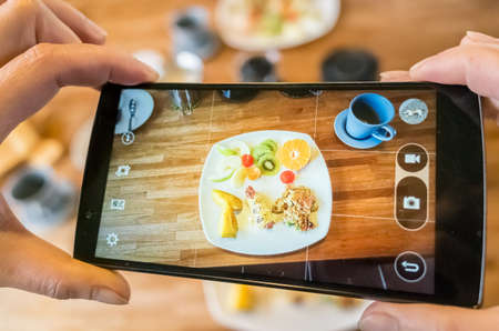 taking photo at breakfast on tableの写真素材