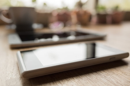 mobile on wooden desk with nobody in the roomの写真素材