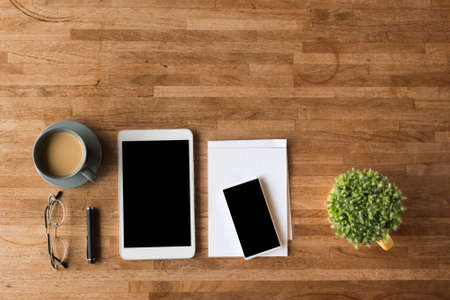 smartphone and tablet on wooden desk with nobodyの写真素材