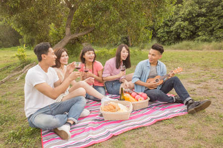 Asian people take a picnic with wineの写真素材