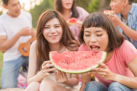 Asian people take a picnic with watermelonの写真素材